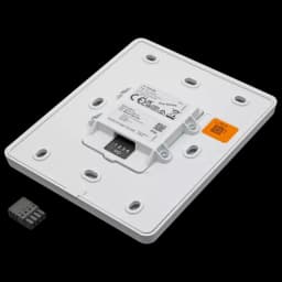 White volume controller for wall mount. C8310 is from Axis Communications - viewed from its right angle