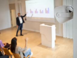 AXIS C1110-E from AXIS COMMUNICATIONS - on wall in lecturehall